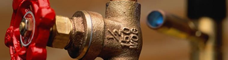 Shut-off valve on copper pipe; blowtorch in background